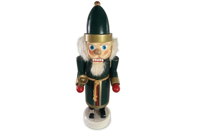 Wooden Christmas nutcracker soldier in green and gold uniform