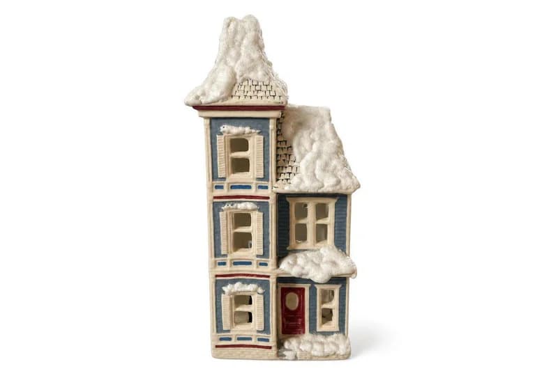 Ceramic Christmas village house with snow-covered roof and red door