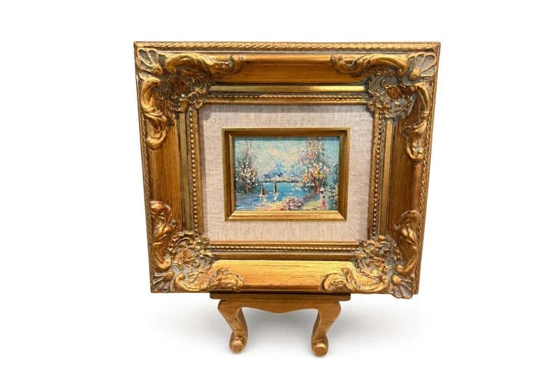Ornate gilt-framed miniature landscape painting on easel