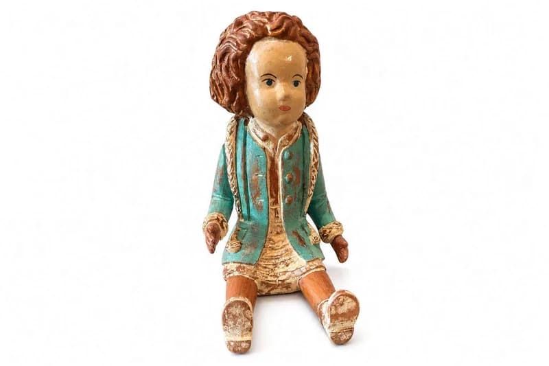 Hand-carved wooden seated folk art doll